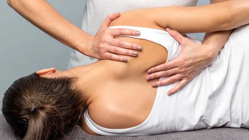 A patient receiving a shoulder blade treatment
